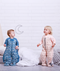 Two toddlers wearing ergoPouch Sleep Suit Sack