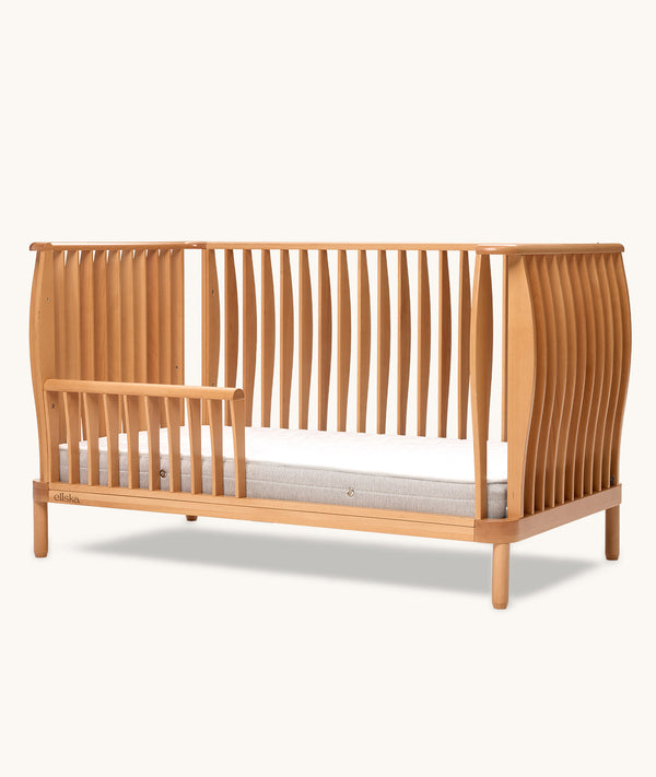 Ecom shot of the ergoPouch ellska Skye Crib that has converted into a toddler bed, mattress not included
