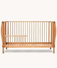 Product shot of the ergoPouch ellska Skye Crib that has converted into a toddler bed.
