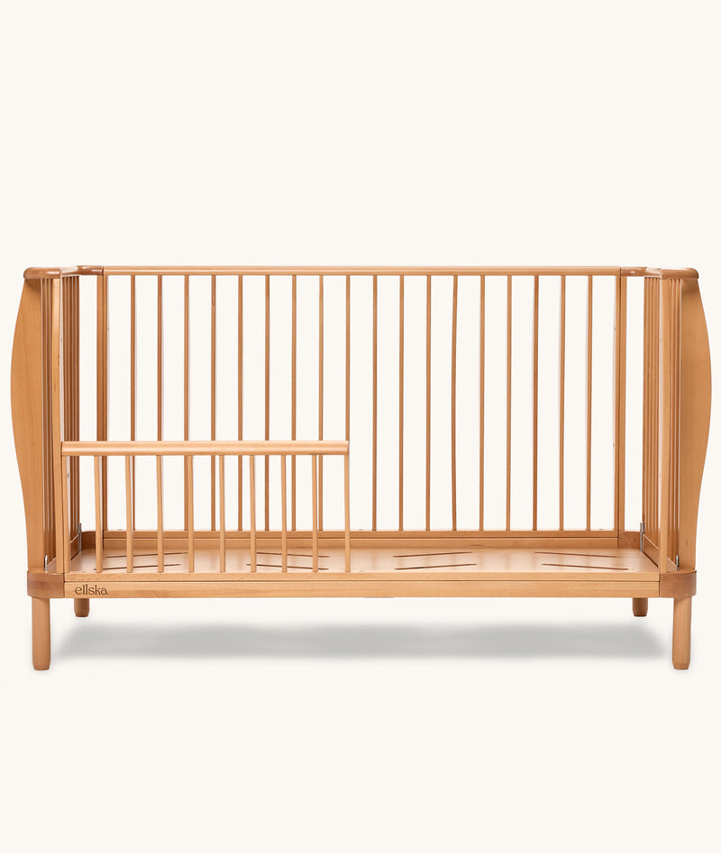 Product shot of the ergoPouch ellska Skye Crib that has converted into a toddler bed.
