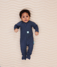 Newborn wearing an ergoPouch Long Sleeve Romper 1.0 TOG Ink