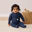 Newborn sitting in ergoPouch Long Sleeve Romper 1.0 TOG Ink