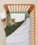 Product shot of  a crib and ergoPouch toddler pillow case in Midnight stripe