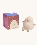 Soft-touch silicone bedtime lamp shaped like a smiling, rounded character with arms and legs, sitting next to its box labelled Blobby Bedtime Lamp by ergoPouch.