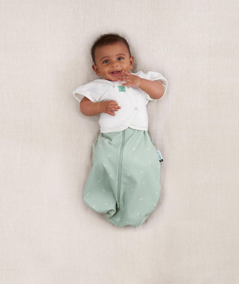 Baby wearing an ergoPouch Butterfly Cardi Natural with both arms out of swaddle