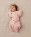 Newborn being swaddled in ergoPouch Cocoon Swaddle Sack 1.0 TOG with Butterfly Cardi for arms up sleeping, in heritage color Daisies
