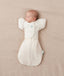 Newborn being swaddled in ergoPouch Cocoon Swaddle Sack 1.0 TOG Oatmeal Marle with Butterfly Cardi Oatmeal Marle for arms up sleeping
