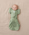 Newborn wearing ergoPouch Butterfly Cardi Willow and a matching Pouch