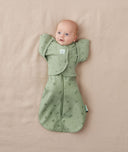 Newborn being swaddled in ergoPouch Cocoon Swaddle Sack 0.2 TOG with Butterfly Cardi for arms up sleeping, in heritage color Willow