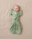 Newborn being swaddled in ergoPouch Cocoon Swaddle Sack 0.2 TOG with Butterfly Cardi for arms up sleeping, in heritage color Willow