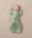 Newborn being swaddled in ergoPouch Cocoon Swaddle Sack 1.0 TOG with Butterfly Cardi for arms up sleeping, in heritage color Willow