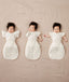 Newborns being swaddled in ergoPouch Cocoon Swaddle Sack 1.0 TOG Oatmeal Marle with Butterfly Cardi Oatmeal Marle for arms up sleeping, transitioning to arms out