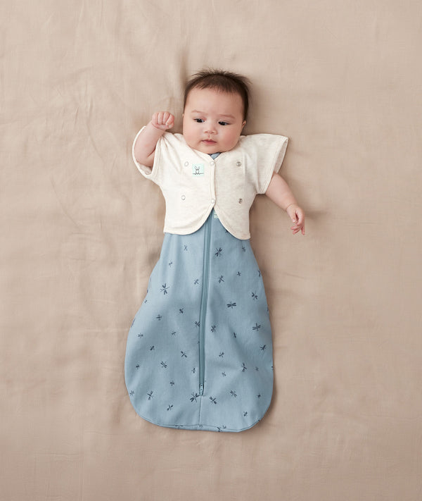 Baby sleeping with arms out in a ergoPouch Newborn Spring Sleep Style Bundles