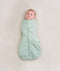 Newborn wearing an ergoPouch Cocoon Swaddle Sack 2.5 TOG Sage with arms in