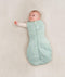 Baby being swaddled in ergoPouch Cocoon Swaddle Sack in Sage