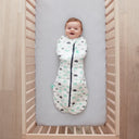 Baby lying on a crib  wearing a Cocoon Swaddle Sack 2.5 TOG with its arms in