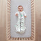 Baby lying on a crib  wearing Cocoon Swaddle Sack 2.5 TOG with its arms out