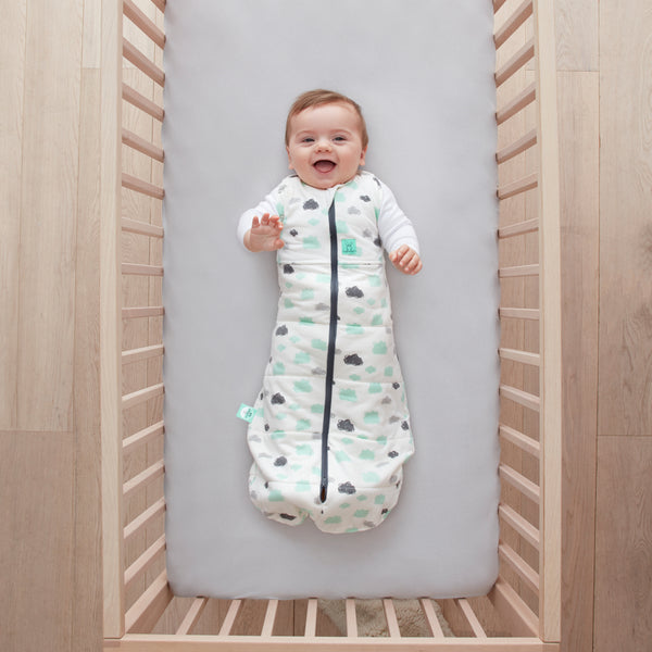 Baby lying on a crib  wearing Cocoon Swaddle Sack 2.5 TOG with its arms out