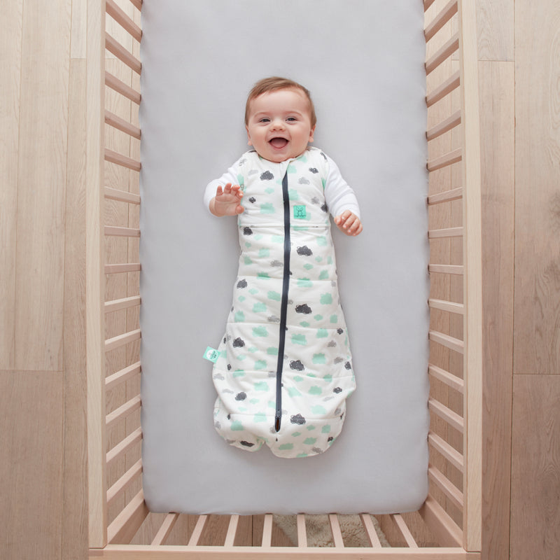 Baby lying on a crib  wearing Cocoon Swaddle Sack 2.5 TOG with its arms out