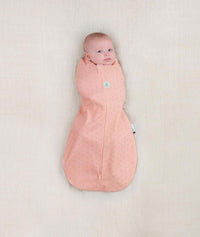 Newborn wearing an ergoPouch Cocoon Swaddle Sack 0.2 TOG Berries with arms in