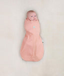 Newborn wearing an ergoPouch Cocoon Swaddle Sack 1.0 TOG Berries with arms in