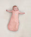 Newborn wearing ergoPouch Cocoon Swaddle Sack 0.2 TOG Berries, transitioning to arms out sleeping