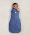 Newborn wearing ergoPouch Cocoon Swaddle Sack 0.2 TOG Night Sky, transitioning to arms out sleeping