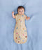 Baby sleeping with arms out in a ergoPouch Cocoon Swaddle Sack 1.0 TOG Birthday Blobs