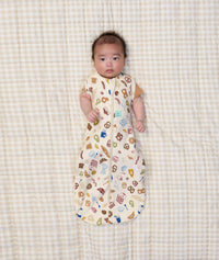 Newborn wearing ergoPouch Cocoon Swaddle Sack 1.0 TOG in Bon Appetit with both arms out