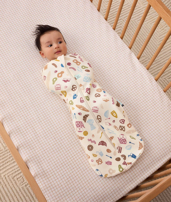 Newborn baby wearing ergoPouch Cocoon Swaddle Sack 1.0 TOG in Bon Appetit