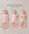 Three side-by-side images showing a baby demonstrating how to transition a pink floral swaddle into an arms-out sleep sack.