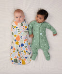 Two lying sitting in ergoPouch Long Sleeve Romper 1.0 TOG Sweet Orchard and Cocoon Swaddle Sack 1.0 TOG Fruit Salad