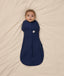 Baby snuggled in ergoPouch Cocoon Swaddle Sack with its arms in.