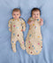 Smiling newborns ergoPouch Long Sleeve Romper 1.0 TOG Birthday Blobs and Long Sleeve Romper 0.2 TOG Birthday Blob, transitioning arms out sleeping