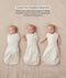 Three side-by-side images showing a baby demonstrating how to transition an ergoPouch Cocoon swaddle Sack into an arms-out Sleep Sack.