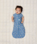 Newborn baby wearing ergoPouch Cocoon Swaddle Sack 1.0 TOG in Petite Pretzel with their arms out