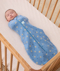 Newborn baby asleep wearing ergoPouch Cocoon Swaddle Sack 0.2 TOG in Petit Pretzel