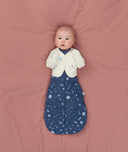 Newborn using Butterfly Cardi Oamteal Marle for arms up sleeping, wearing a ergoPouch Cocoon Swaddle Sack 1.0 TOG Starbeam underneath