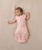 Newborn wearing ergoPouch Cocoon Swaddle Sack 0.2 TOG Daisies, transitioning to arms out sleeping
