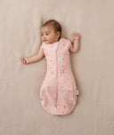 Baby sleeping with arms out in a ergoPouch Cocoon Swaddle Sack 1.0 TOG Daisies