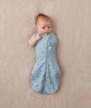 Baby wearing a ergoPouch Cocoon Swaddle Sack 1.0 TOG Dragonflies, transitioning to arms out sleeping