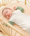 Baby sleeping with arms out in a ergoPouch Cocoon Swaddle Sack 0.2 TOG Oatmeal Marle