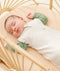 Baby sleeping with arms out in a ergoPouch Cocoon Swaddle Sack 0.2 TOG Oatmeal Marle