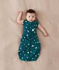 Baby sleeping with arms out in a ergoPouch Cocoon Swaddle Sack 0.2 TOG Ocean Blue