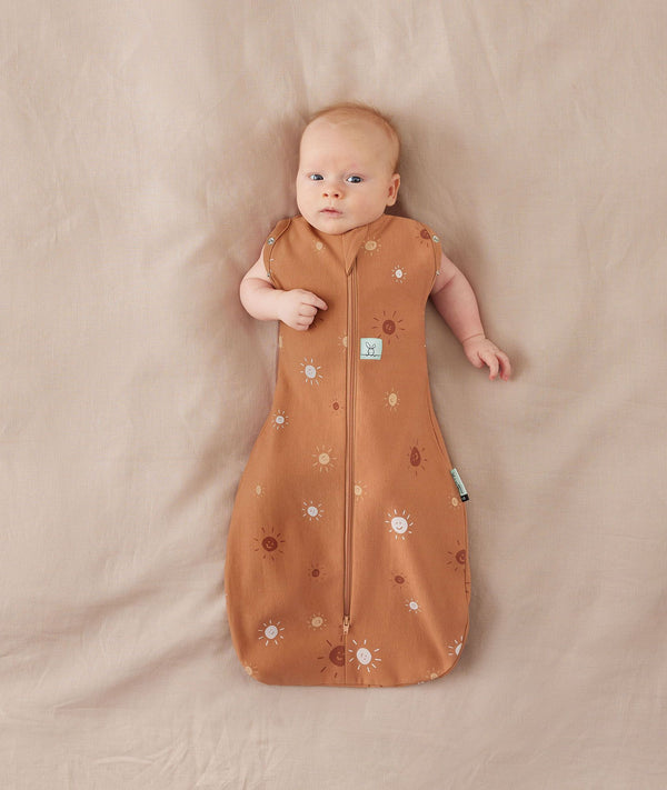 Baby sleeping with arms out in a ergoPouch Cocoon Swaddle Sack 0.2 TOG Sunny