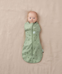 Newborrn being swaddled in ergoPouch Cocoon Swaddle Sack 0.2 TOG Willow