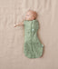 Baby wearing a ergoPouch Cocoon Swaddle Sack 0.2 TOG Willow, transitioning to arms out sleeping