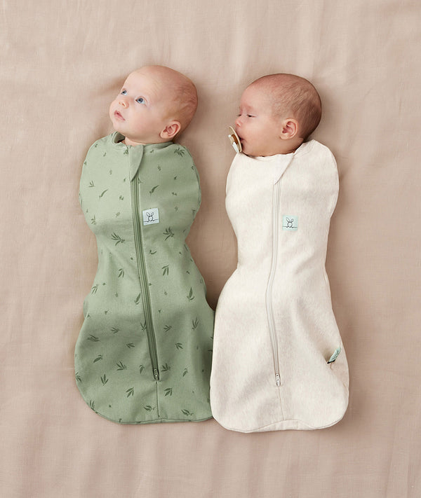 Newborns swaddled in ergoPouch Cocoon Swaddle Sack Willow and Oatmeal Marle, perfect for the summer