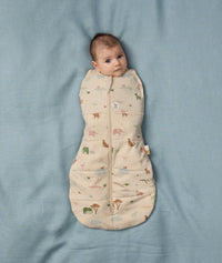 Baby snuggled in ergoPouch Cocoon Swaddle Sack 2.5 TOG Savannah