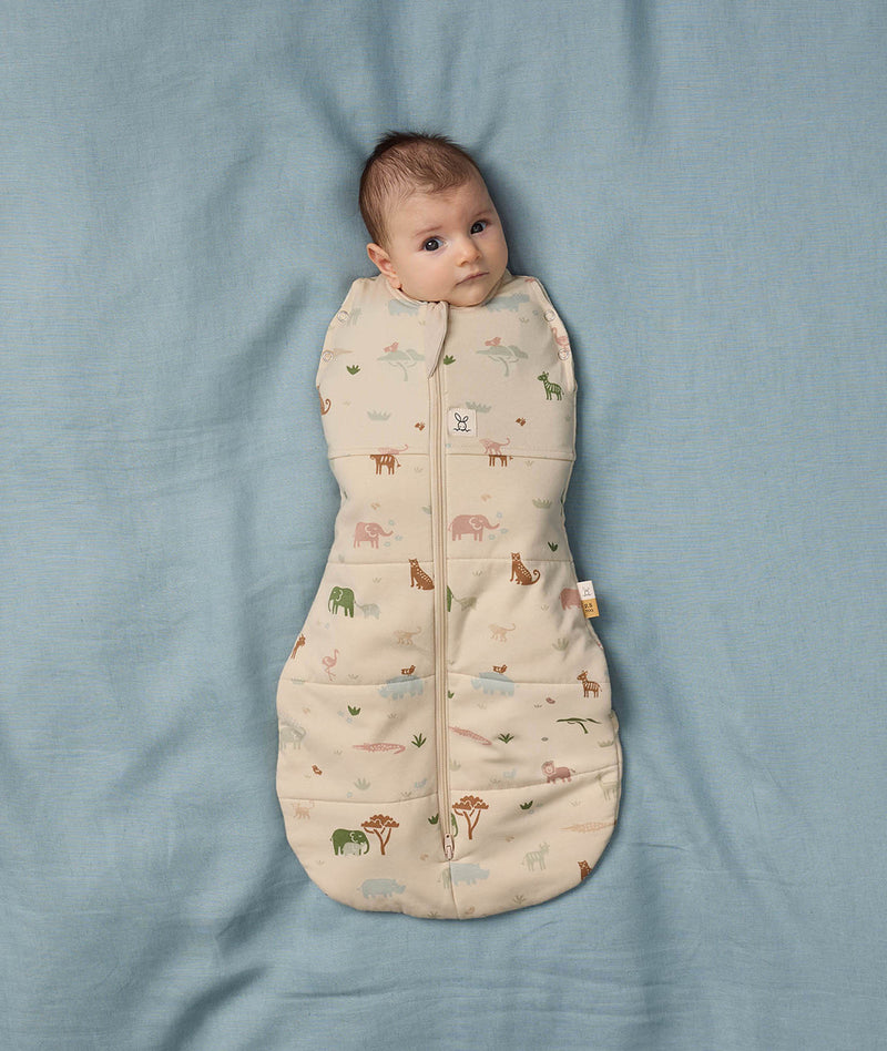 Baby snuggled in ergoPouch Cocoon Swaddle Sack 2.5 TOG Savannah